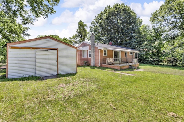 1196 S Dettman Rd, Jackson, MI 49203 - back of house with a yard, an outdoor structure, covered porch, and a chimney