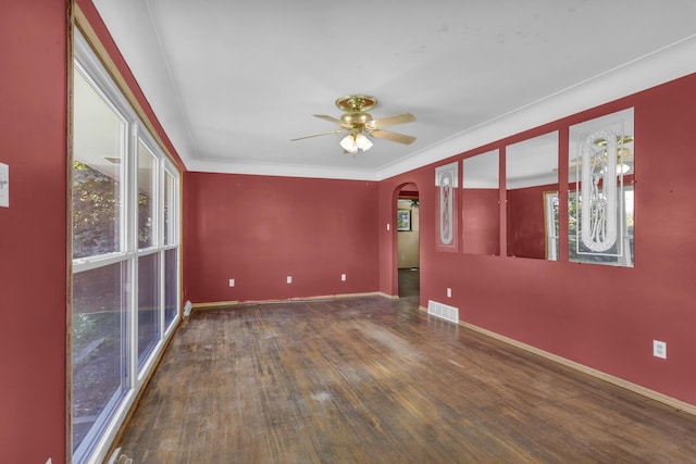 1196 S Dettman Rd, Jackson, MI 49203 - unfurnished room with arched walkways, wood finished floors, healthy amount of natural light, and ceiling fan
