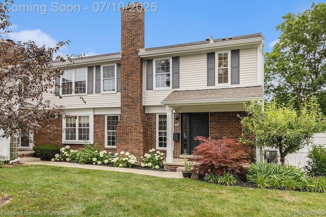 42173 Pellston Dr, Northville, MI 48167 - view of front of property featuring a front lawn, a chimney, and brick siding