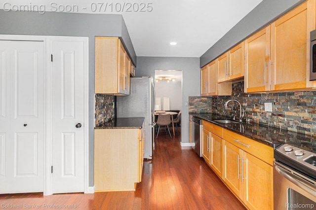 42173 Pellston Dr, Northville, MI 48167 - kitchen featuring stainless steel appliances, light brown cabinets, dark stone countertops, and recessed lighting