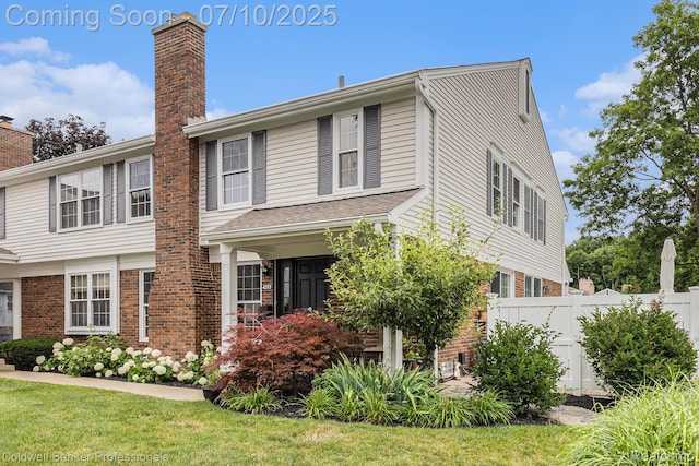 42173 Pellston Dr, Northville, MI 48167 - view of front facade with brick siding and a chimney