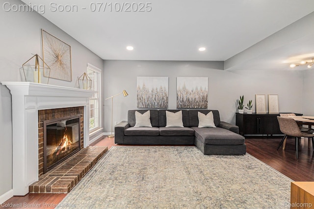 42173 Pellston Dr, Northville, MI 48167 - living area featuring wood finished floors, a brick fireplace, and recessed lighting