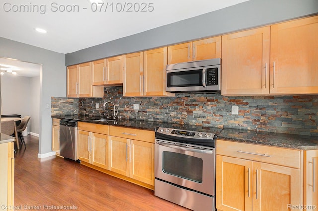 42173 Pellston Dr, Northville, MI 48167 - kitchen featuring stainless steel appliances, light brown cabinetry, tasteful backsplash, dark stone counters, and recessed lighting