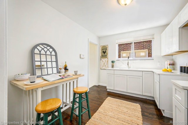 18661 Stoepel St, Detroit, MI 48221 - kitchen with dark wood-style flooring, light countertops, and white cabinetry