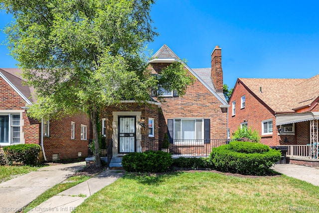 18661 Stoepel St, Detroit, MI 48221 - view of front facade with a chimney, a front lawn, and brick siding