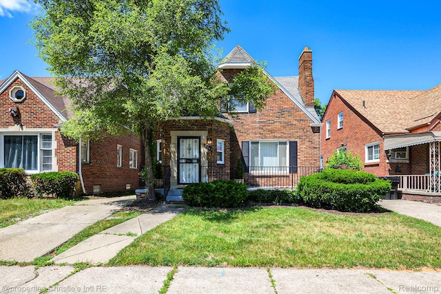 18661 Stoepel St, Detroit, MI 48221 - view of front of property with brick siding, a front lawn, and a chimney