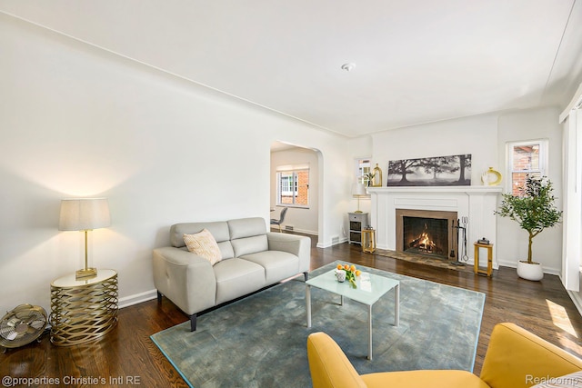 18661 Stoepel St, Detroit, MI 48221 - living room with wood finished floors, arched walkways, and a fireplace with flush hearth