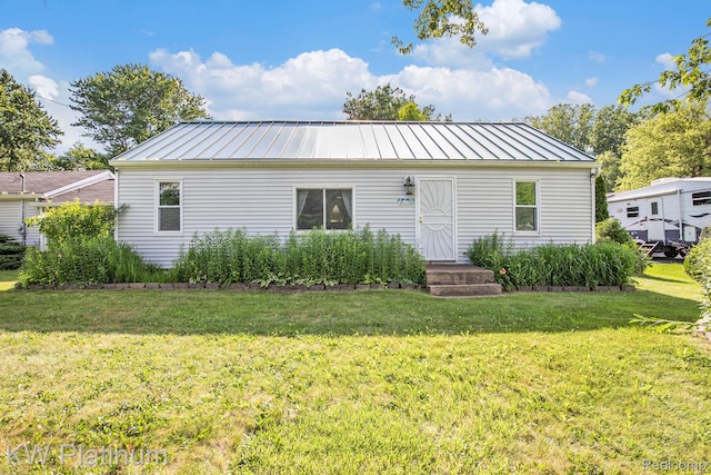 1509 Allen Rd, Kimball, MI 48074 - back of property featuring a yard, a standing seam roof, and a metal roof