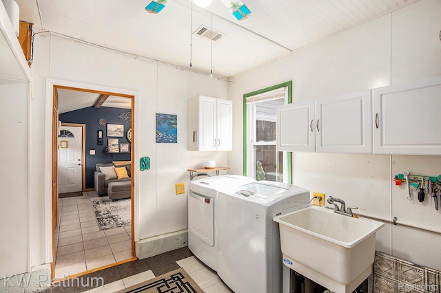 1509 Allen Rd, Kimball, MI 48074 - washroom with cabinet space, washer and clothes dryer, and light tile patterned floors