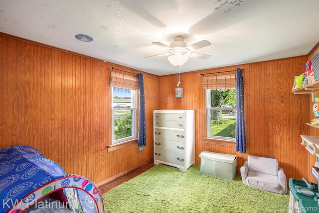 1509 Allen Rd, Kimball, MI 48074 - bedroom featuring wood walls, a ceiling fan, and carpet