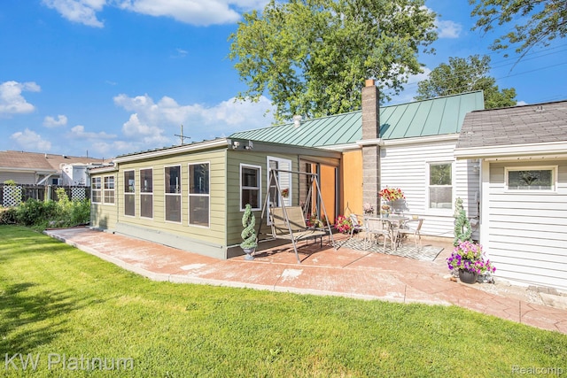 1509 Allen Rd, Kimball, MI 48074 - rear view of property with a chimney, a patio area, a metal roof, and a standing seam roof