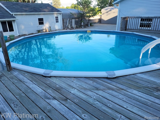 1509 Allen Rd, Kimball, MI 48074 - swimming pool featuring a wooden deck and a fenced backyard