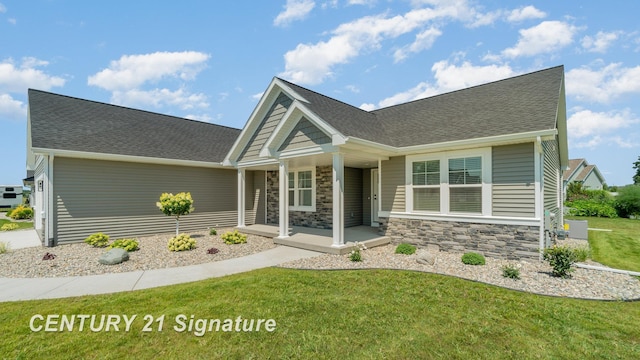 10464 Laurel Woods Pl, Freeland, MI 48623 - craftsman inspired home featuring covered porch, a front lawn, roof with shingles, and stone siding