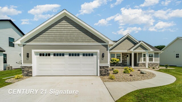 10464 Laurel Woods Pl, Freeland, MI 48623 - craftsman-style house with stone siding, driveway, a garage, and a porch
