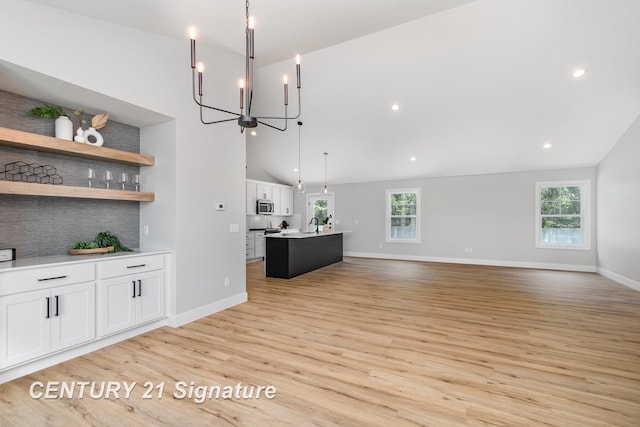 10464 Laurel Woods Pl, Freeland, MI 48623 - unfurnished living room featuring plenty of natural light, light wood-style floors, a chandelier, recessed lighting, and high vaulted ceiling