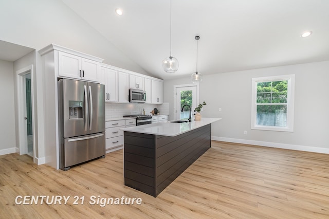 10464 Laurel Woods Pl, Freeland, MI 48623 - kitchen with appliances with stainless steel finishes, white cabinets, tasteful backsplash, light wood finished floors, and recessed lighting