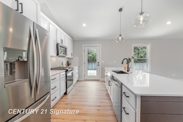 10464 Laurel Woods Pl, Freeland, MI 48623 - kitchen featuring stainless steel appliances, light countertops, light wood-style floors, healthy amount of natural light, and recessed lighting