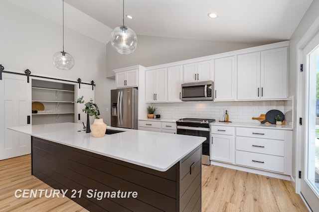 10464 Laurel Woods Pl, Freeland, MI 48623 - kitchen featuring stainless steel appliances, white cabinets, light wood finished floors, decorative backsplash, and plenty of natural light