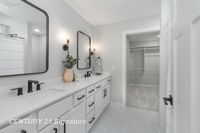 10464 Laurel Woods Pl, Freeland, MI 48623 - bathroom featuring marble finish flooring, double vanity, and a spacious closet