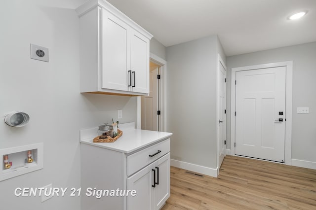 10464 Laurel Woods Pl, Freeland, MI 48623 - laundry room featuring washer hookup, cabinet space, electric dryer hookup, light wood-type flooring, and recessed lighting