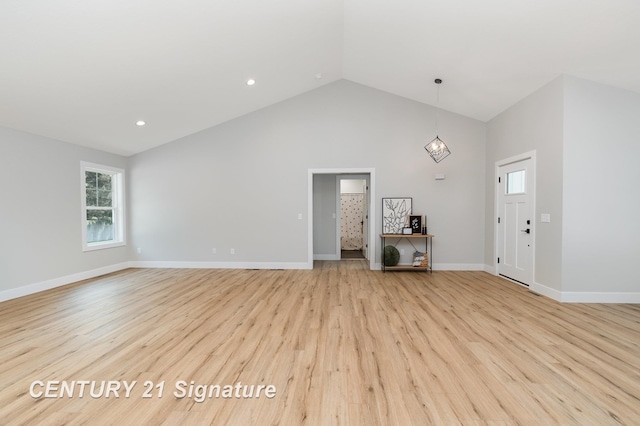 10464 Laurel Woods Pl, Freeland, MI 48623 - unfurnished living room with light wood finished floors, high vaulted ceiling, and recessed lighting