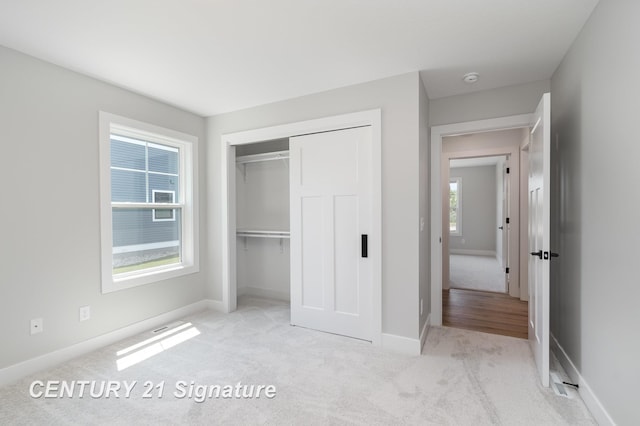 10464 Laurel Woods Pl, Freeland, MI 48623 - unfurnished bedroom featuring carpet and a closet