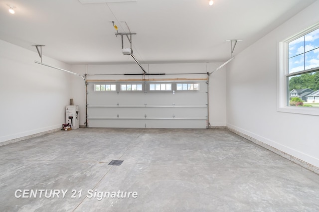10464 Laurel Woods Pl, Freeland, MI 48623 - garage with baseboards and a garage door opener