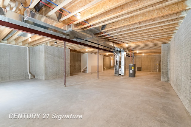 10464 Laurel Woods Pl, Freeland, MI 48623 - unfinished basement featuring stairs, heating unit, electric water heater, and brick wall