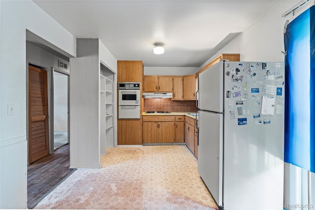 5428 Farmhill Rd, Flint, MI 48505 - kitchen with white appliances, light floors, a warming drawer, and brown cabinets