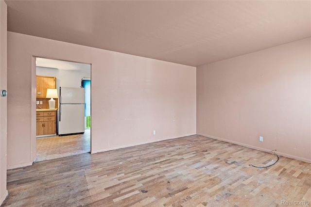 5428 Farmhill Rd, Flint, MI 48505 - spare room with light wood-style floors and baseboards