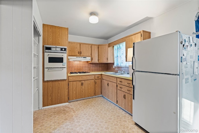 5428 Farmhill Rd, Flint, MI 48505 - kitchen with white appliances, under cabinet range hood, light flooring, light countertops, and decorative backsplash