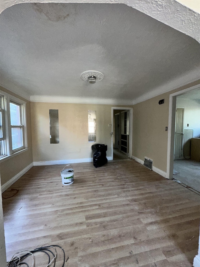 15043 Holmur St, Detroit, MI 48238 - unfurnished living room featuring a textured ceiling and wood finished floors