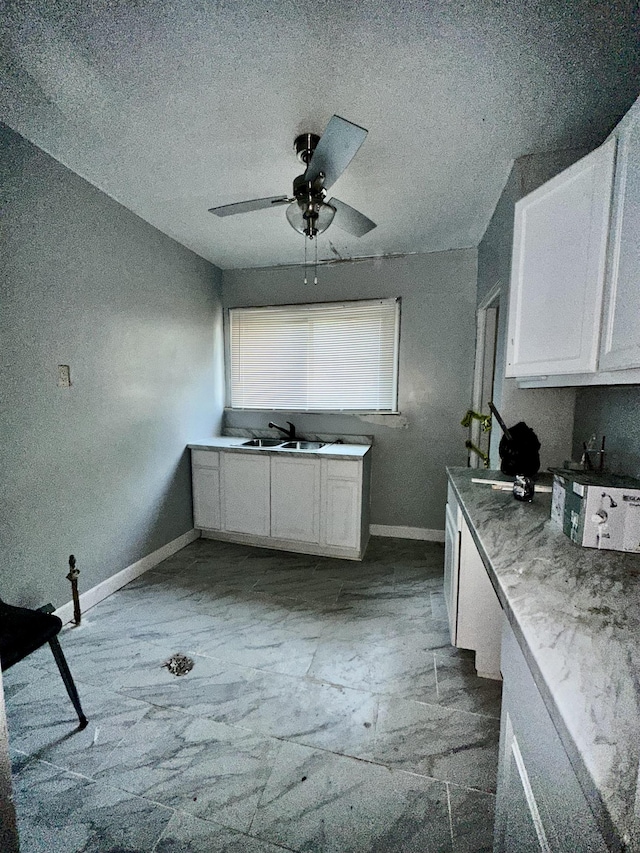 15043 Holmur St, Detroit, MI 48238 - kitchen with ceiling fan, white cabinets, and a textured ceiling