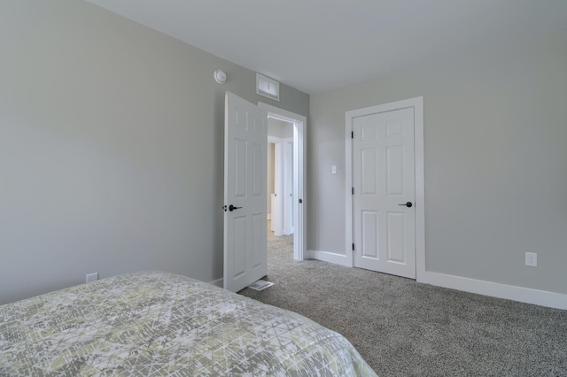 609 W Biddle St, Jackson, MI 49203 - carpeted bedroom featuring baseboards