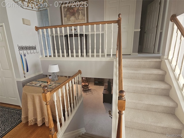 38412 Sutton Dr, Sterling Heights, MI 48310 - stairs with a chandelier and wood finished floors