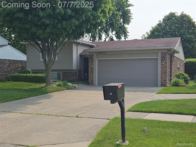 38412 Sutton Dr, Sterling Heights, MI 48310 - tri-level home featuring driveway, brick siding, an attached garage, and a front lawn
