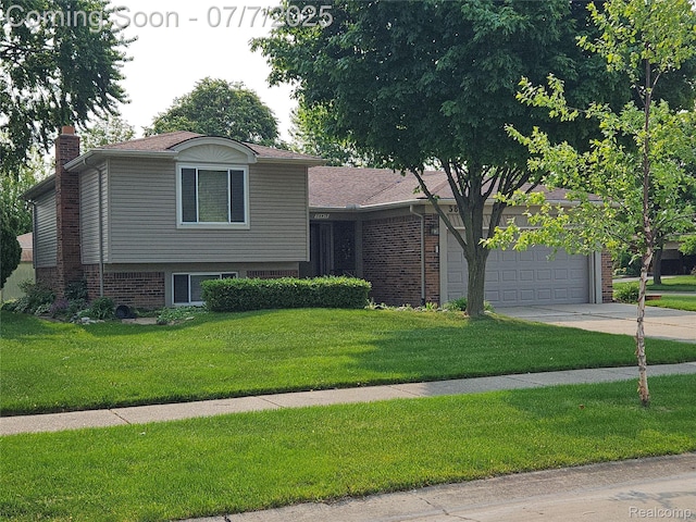 38412 Sutton Dr, Sterling Heights, MI 48310 - split level home featuring driveway, a garage, a chimney, a front yard, and brick siding