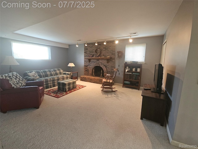 38412 Sutton Dr, Sterling Heights, MI 48310 - carpeted living room featuring track lighting, a fireplace, and healthy amount of natural light