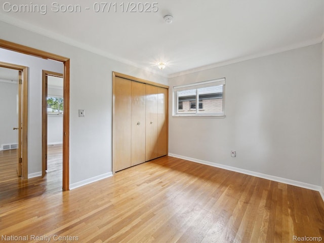 29620 Oakview St, Livonia, MI 48154 - unfurnished bedroom featuring multiple windows, light wood-style floors, and a closet