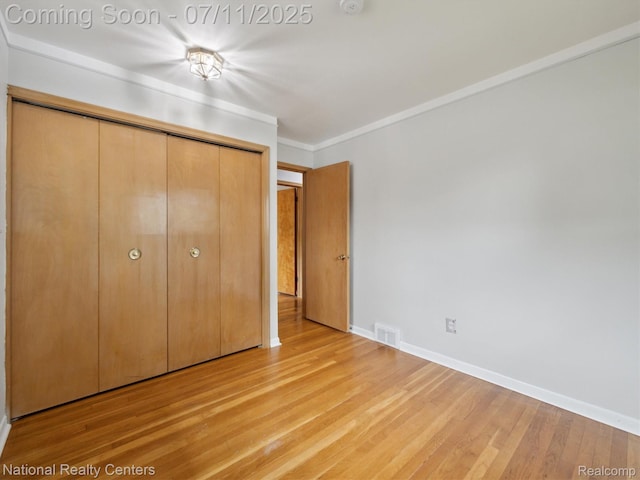 29620 Oakview St, Livonia, MI 48154 - unfurnished bedroom featuring light wood-style floors, a closet, and crown molding