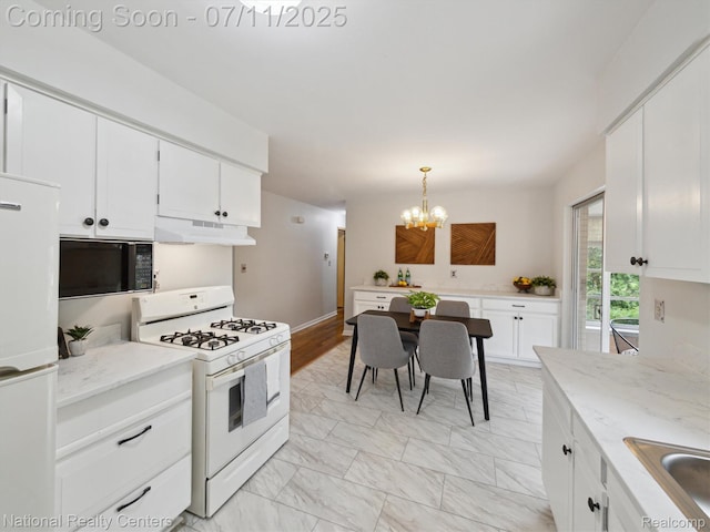 29620 Oakview St, Livonia, MI 48154 - kitchen featuring white appliances, under cabinet range hood, a chandelier, white cabinetry, and pendant lighting