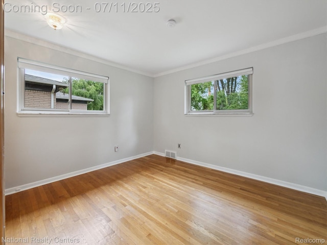 29620 Oakview St, Livonia, MI 48154 - unfurnished room featuring ornamental molding, healthy amount of natural light, wood-type flooring, and a smoke detector