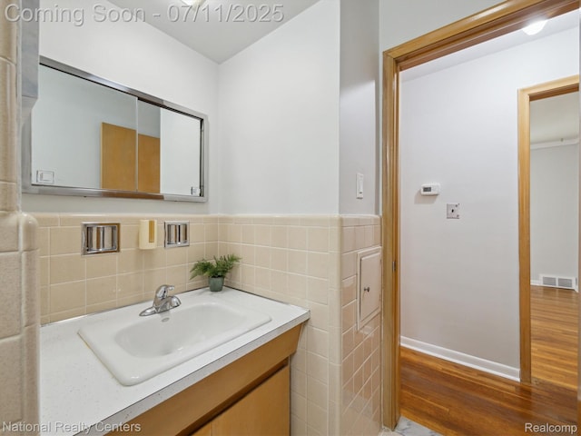 29620 Oakview St, Livonia, MI 48154 - bathroom with wood finished floors, vanity, and tile walls