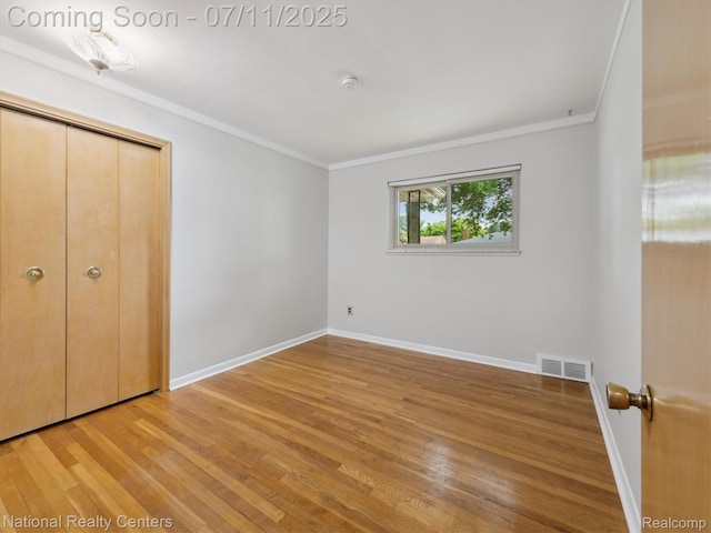 29620 Oakview St, Livonia, MI 48154 - unfurnished bedroom with ornamental molding, light wood-style floors, and a closet