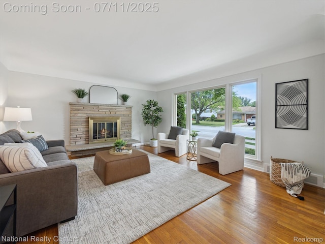 29620 Oakview St, Livonia, MI 48154 - living area featuring wood finished floors and a fireplace