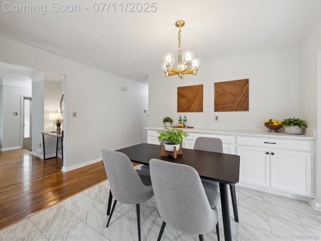 29620 Oakview St, Livonia, MI 48154 - dining area featuring a chandelier and light marble finish floors
