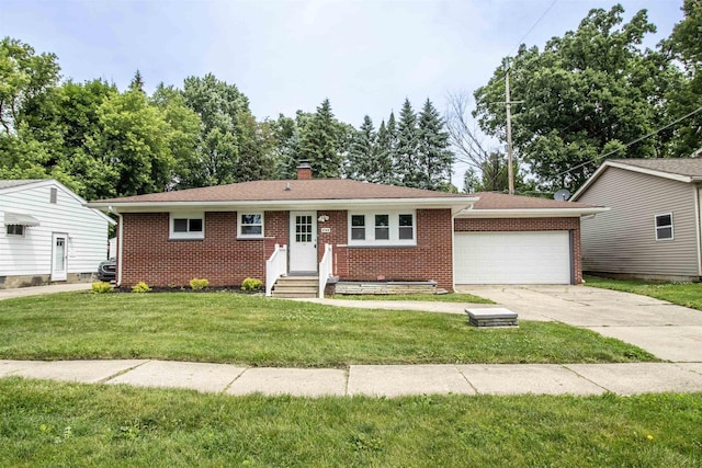 3745 Holly Ave, Flint, MI 48506 - single story home with brick siding, driveway, an attached garage, and a front yard