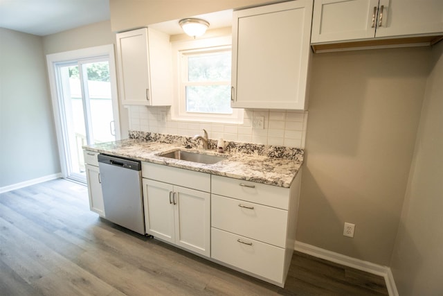 3745 Holly Ave, Flint, MI 48506 - kitchen featuring dishwasher, backsplash, wood finished floors, light stone counters, and white cabinetry