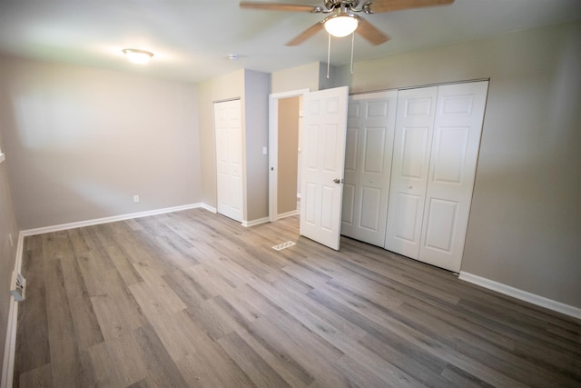 3745 Holly Ave, Flint, MI 48506 - unfurnished bedroom with multiple closets and wood finished floors