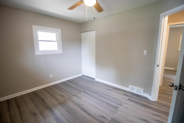 3745 Holly Ave, Flint, MI 48506 - unfurnished bedroom with wood finished floors, a closet, and ceiling fan
